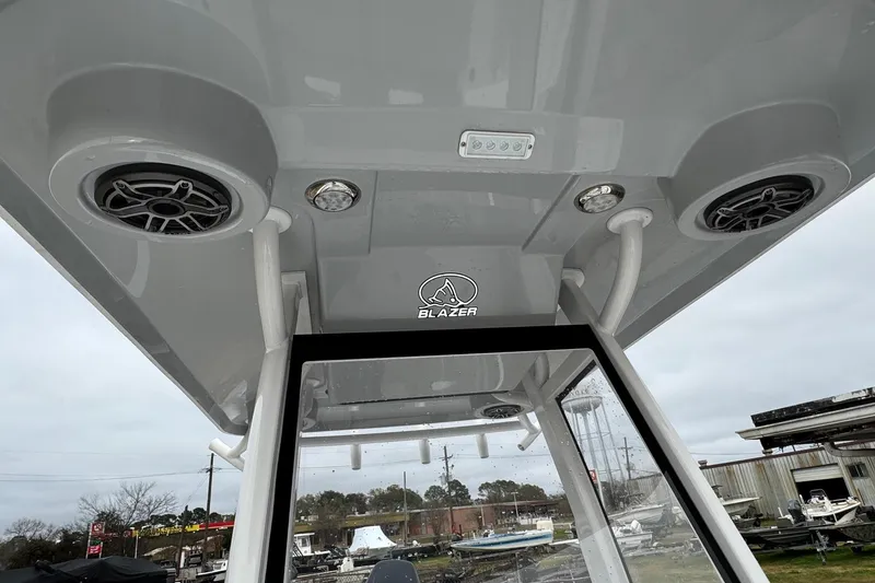 Slide: The Image of 2026 Blazer Bay 2440 boat console with speakers and lighting, outdoor setting. - 36