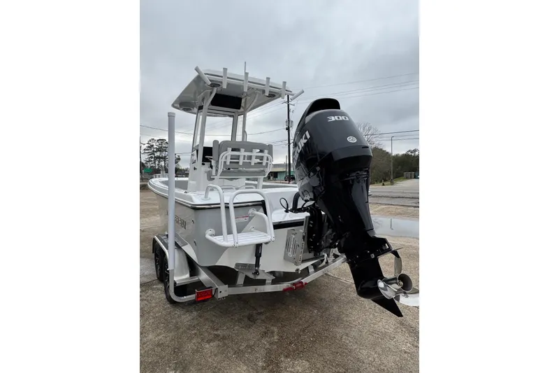 Slide: The Image of 2026 Blazer Bay 2440 boat with Suzuki 300 outboard motor, parked on a trailer. - 5