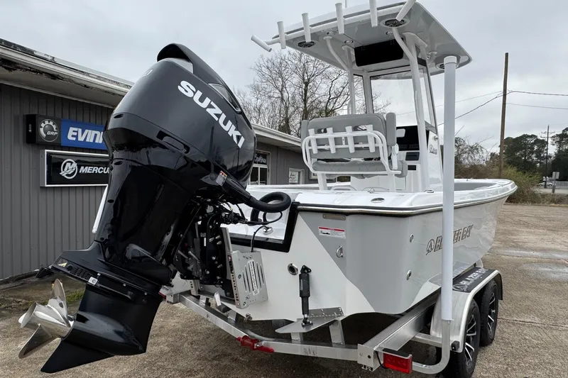 Slide: The Image of 2026 Blazer Bay 2440 boat with Suzuki outboard motor on trailer. - 6