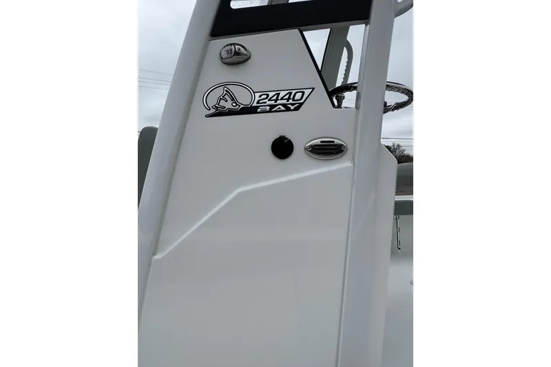 Slide: The Image of 2026 Blazer Bay 2440 boat console with logo and steering wheel detail. - 8