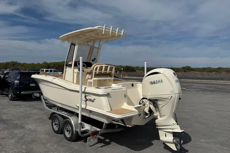 Slide: The Image of 2025 Scout 215 XSF boat with Yamaha engine on trailer in parking lot. - 10