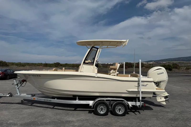 Slide: The Image of 2025 Scout 215 XSF boat on trailer with Yamaha engine, parked outdoors. - 11