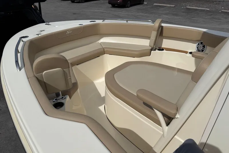 Slide: The Image of 2025 Scout 215 XSF boat interior with beige seating and cup holders. - 15