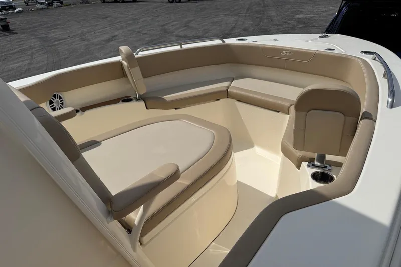 Slide: The Image of 2025 Scout 215 XSF boat interior with beige seating and cup holder. - 16