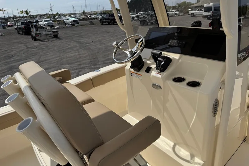 Slide: The Image of 2025 Scout 215 XSF boat interior with steering wheel and control panel. - 18