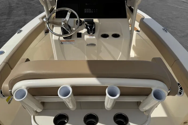 Slide: The Image of 2025 Scout 215 XSF boat interior with steering wheel and rod holders. - 19