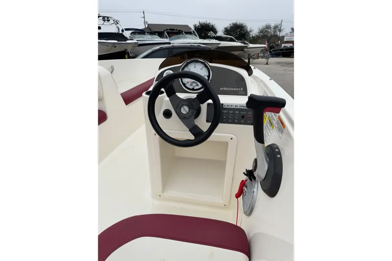 Slide: The Image of 2015 Bayliner Element 180 XL boat dashboard with steering wheel and controls. - 10