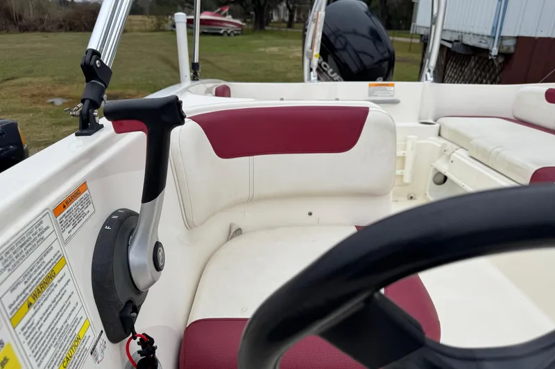 Slide: The Image of Interior view of a 2015 Bayliner Element 180 XL boat with maroon and white seating. - 11