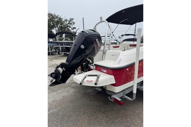 Slide: The Image of 2015 Bayliner Element 180 XL boat with Mercury outboard motor, parked on a trailer. - 4
