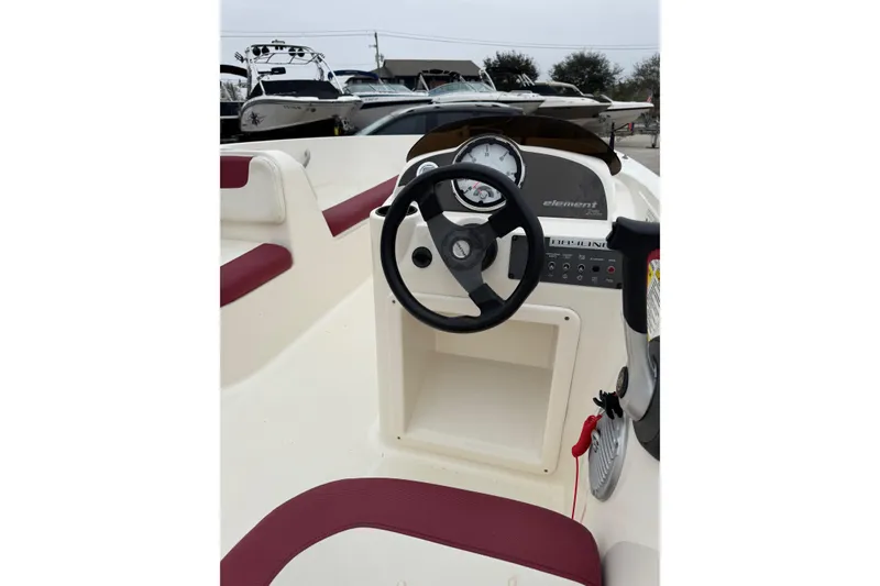 Slide: The Image of 2015 Bayliner Element 180 XL boat dashboard with steering wheel and gauges. - 9