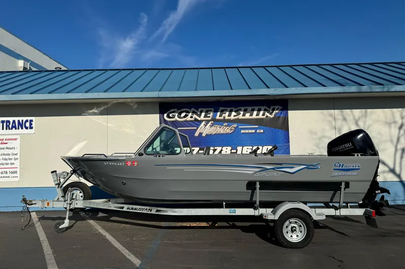 Slide: The Image of 2017 RH Boats 18 SH on trailer, parked outside a marine store. - 0