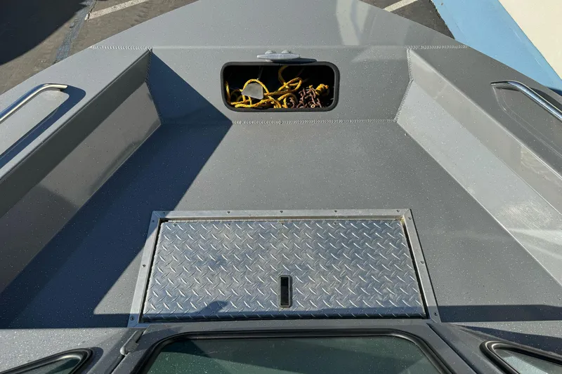 Slide: The Image of 2017 RH Boats 18 SH deck with storage compartment and diamond plate cover. - 11