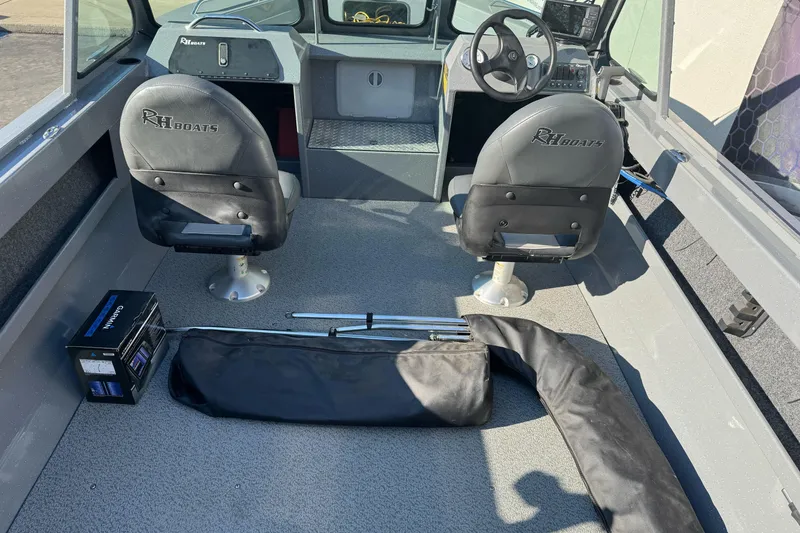 Slide: The Image of 2017 RH Boats 18 SH interior with two seats, steering wheel, and equipment. - 14