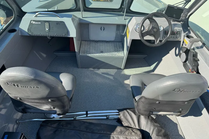 Slide: The Image of Interior of a 2017 RH Boats 18 SH, featuring dual seats and steering console. - 7