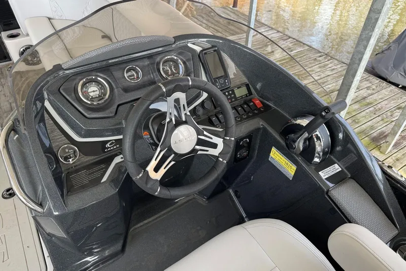 Slide: The Image of Steering console of 2022 Crest Classic Platinum 220 SLRC boat with gauges and controls. - 10