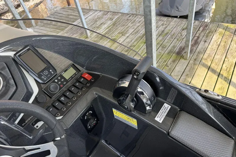 Slide: The Image of 2022 Crest Classic Platinum 220 SLRC boat dashboard with controls and navigation system. - 11