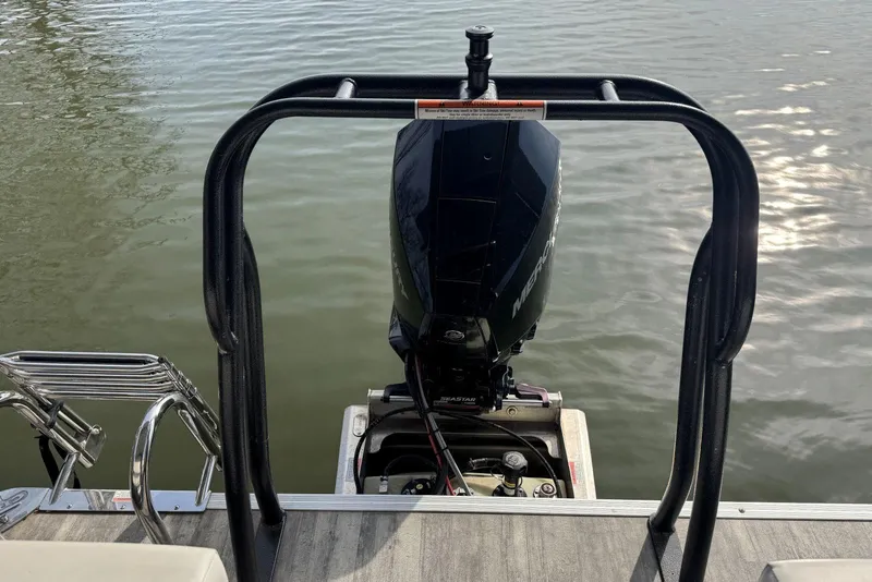 Slide: The Image of 2022 Crest Classic Platinum 220 SLRC boat engine and railing on water. - 14