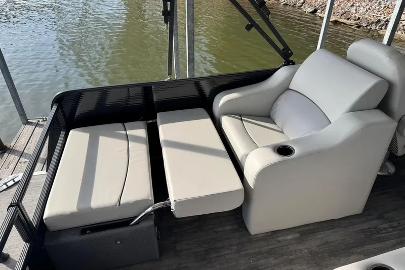 Slide: The Image of 2022 Crest Classic Platinum 220 SLRC boat interior with cushioned seating and cup holder. - 15