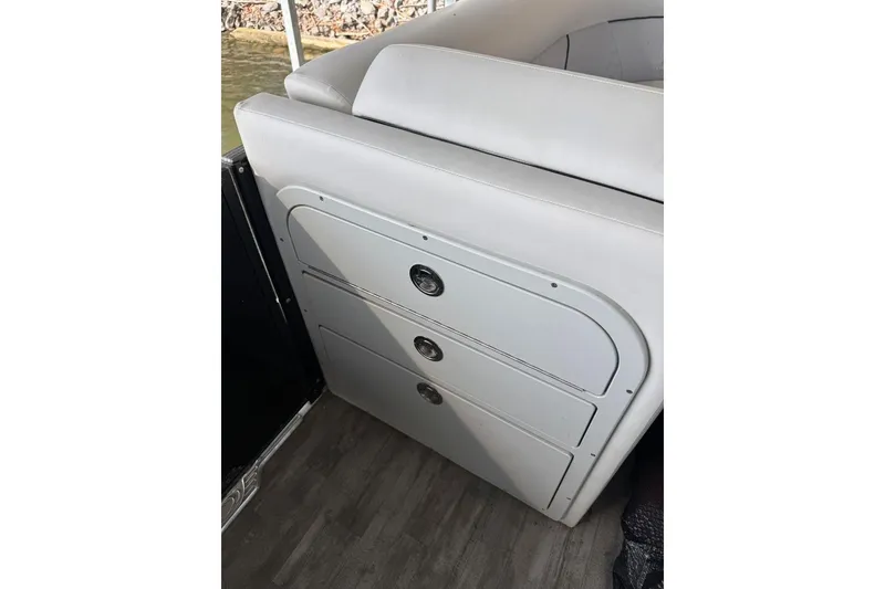 Slide: The Image of 2022 Crest Classic Platinum 220 SLRC boat interior with sleek storage compartments. - 27