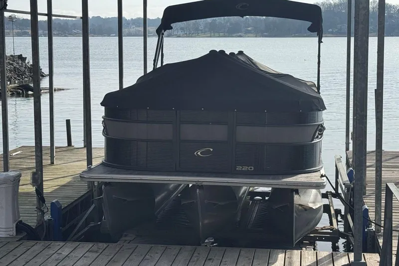 Slide: The Image of 2022 Crest Classic Platinum 220 SLRC pontoon boat docked with cover on. - 35
