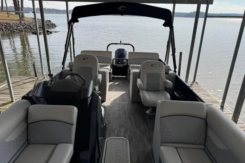 Slide: The Image of 2022 Crest Classic Platinum 220 SLRC pontoon boat interior at dockside. - 5