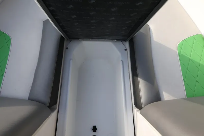 Slide: The Image of Interior seating of 2016 Tigé R22 boat with green and gray upholstery. - 18