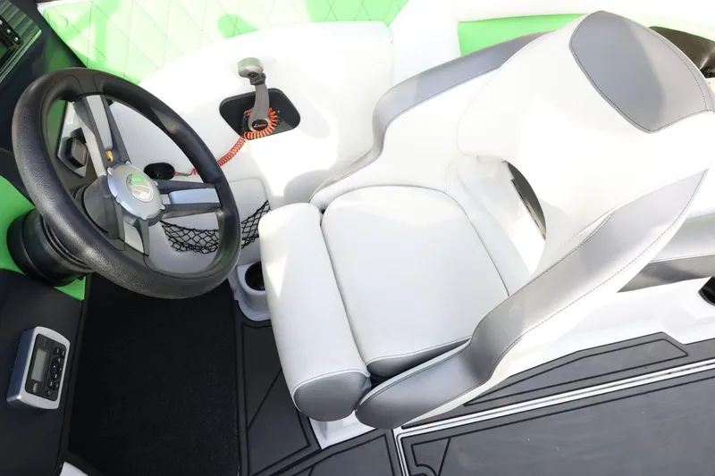 Slide: The Image of 2016 Tigé R22 boat interior with steering wheel and white-gray seating. - 22