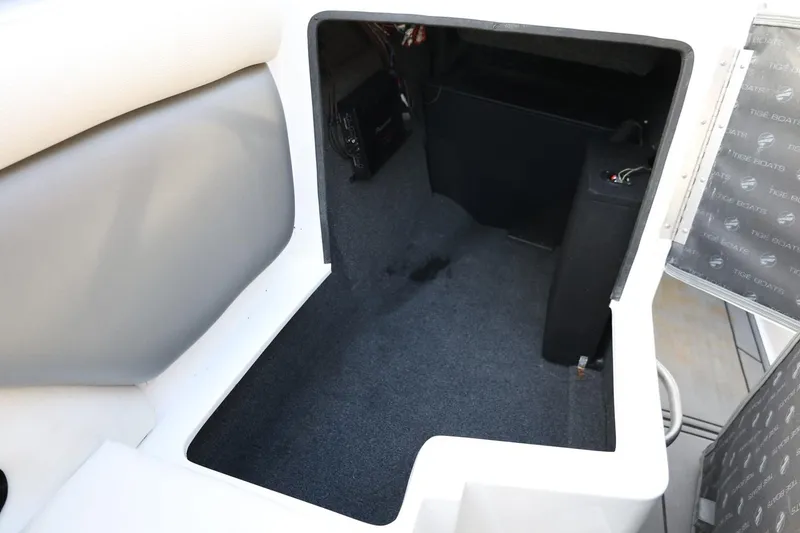 Slide: The Image of 2016 Tigé R22 boat interior storage compartment with carpeted flooring. - 25