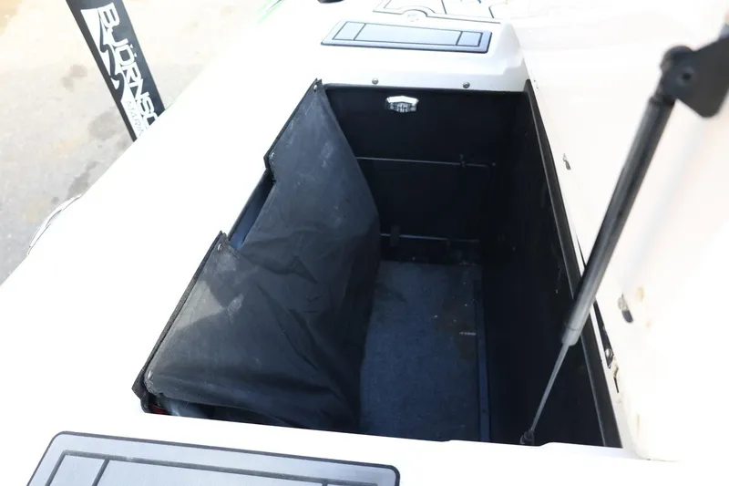 Slide: The Image of 2016 Tigé R22 boat storage compartment with open lid and hydraulic support. - 29