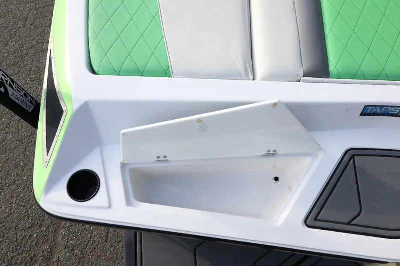 Slide: The Image of 2016 Tigé R22 boat interior with green and white seating, TAPS system visible. - 31