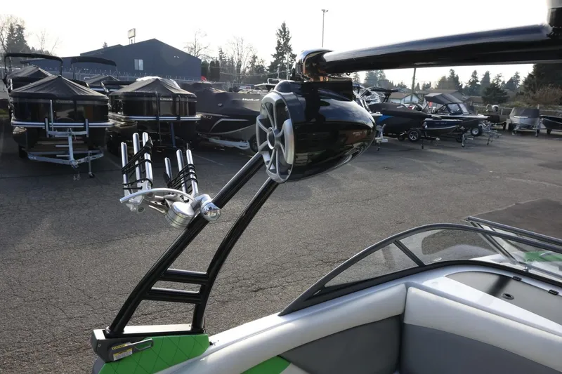 Slide: The Image of 2016 Tigé R22 boat with wakeboard tower and speaker, parked in a marina. - 33