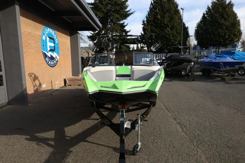 Slide: The Image of 2016 Tigé R22 boat in bright green at Bjornson Marine dealership. - 4