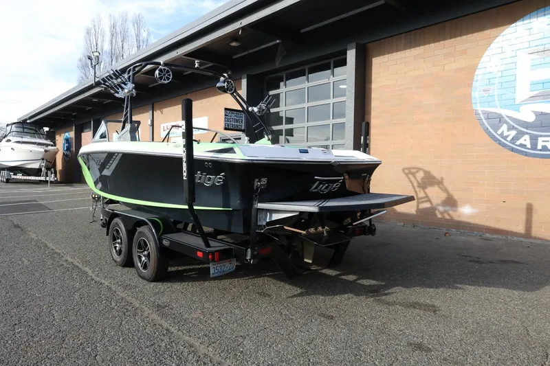 Slide: The Image of 2016 Tigé R22 boat on trailer outside a marine dealership. - 8