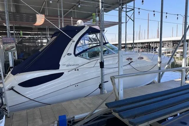 The Image of 2007 Sea Ray 340 Sundancer docked in a marina under a covered slip. - 0