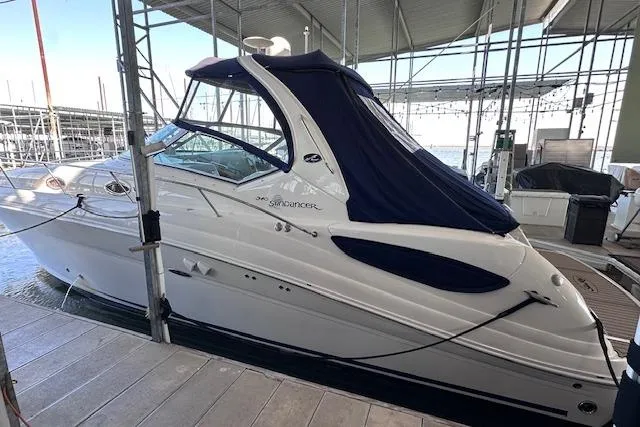 Slide: The Image of 2007 Sea Ray 340 Sundancer docked under a covered marina. - 1