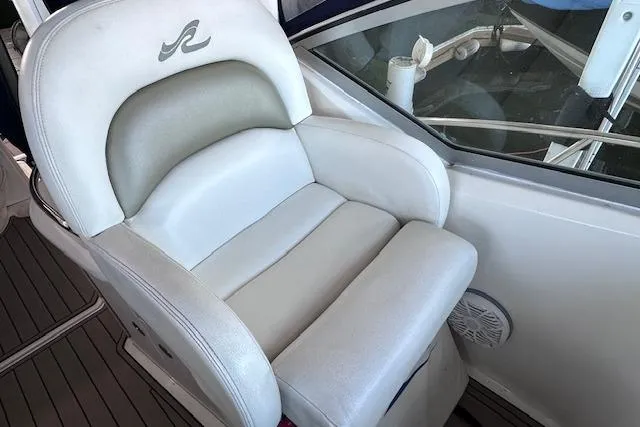Slide: The Image of Captain's seat on 2007 Sea Ray 340 Sundancer boat, featuring white leather upholstery. - 11