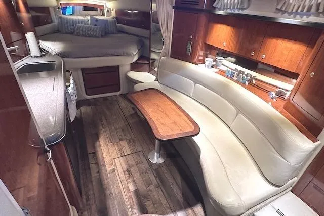Slide: The Image of Luxurious interior of 2007 Sea Ray 340 Sundancer with wood accents and cozy seating area. - 17