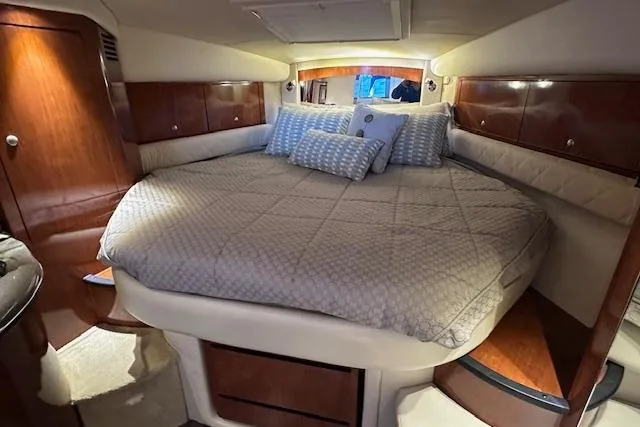 Slide: The Image of Luxurious cabin interior of 2007 Sea Ray 340 Sundancer with cozy bedding and wooden accents. - 18