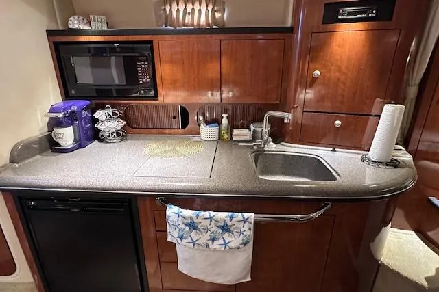 Slide: The Image of 2007 Sea Ray 340 Sundancer galley with microwave, sink, and coffee maker. - 20