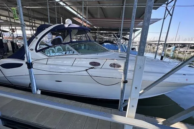 Slide: The Image of 2007 Sea Ray 340 Sundancer docked in a marina under a covered shelter. - 3