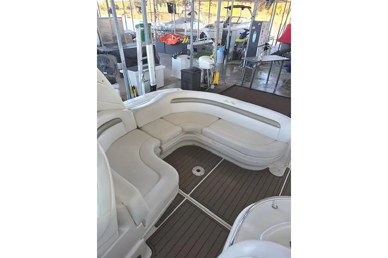 Slide: The Image of 2007 Sea Ray 340 Sundancer boat interior with white seating and wooden flooring. - 35