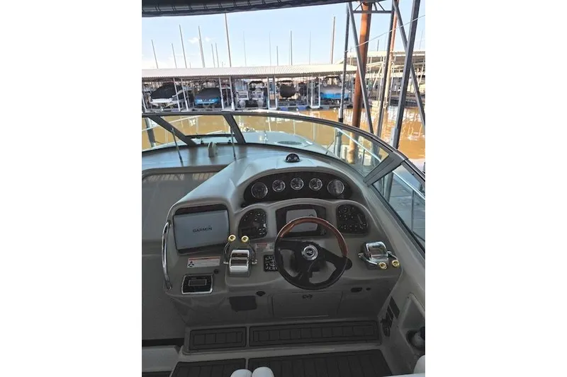 Slide: The Image of 2007 Sea Ray 340 Sundancer helm with Garmin navigation, docked in marina. - 36