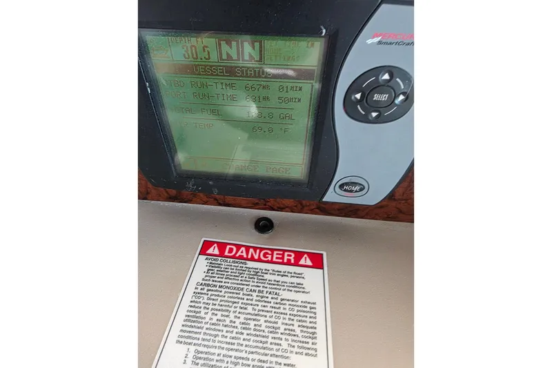 Slide: The Image of 2007 Sea Ray 340 Sundancer dashboard with vessel status display and safety warning label. - 41