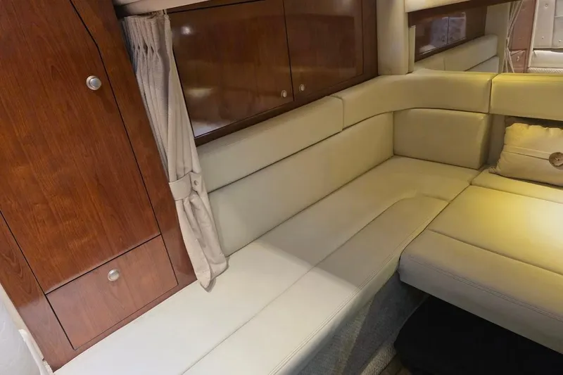 Slide: The Image of 2007 Sea Ray 340 Sundancer interior with beige seating and wooden cabinetry. - 45