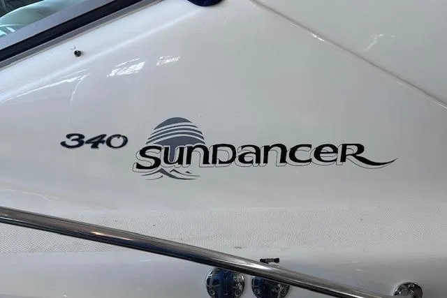 Slide: The Image of 2007 Sea Ray 340 Sundancer boat logo on white hull. - 48