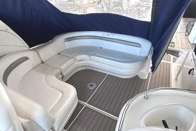 Slide: The Image of 2007 Sea Ray 340 Sundancer interior with white seating and wood flooring. - 7