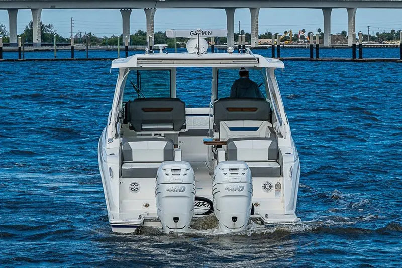 Slide: The Image of 2022 Tiara Yachts 34 LX boat cruising on blue water with twin Mercury engines. - 13