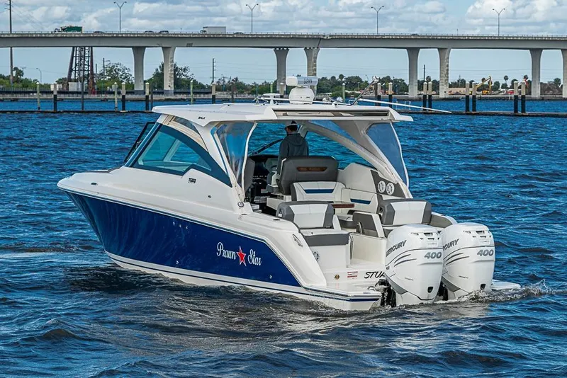 Slide: The Image of 2022 Tiara Yachts 34 LX cruising on water with twin Mercury 400 engines. - 15