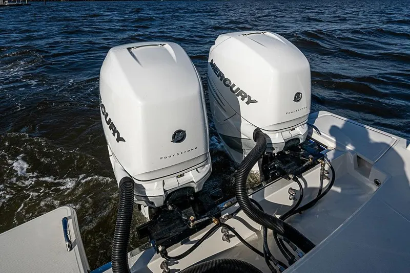 Slide: The Image of 2022 Tiara Yachts 34 LX cruising on a sunny day with scenic waterfront backdrop. - 21