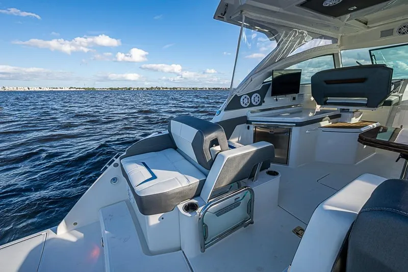 Slide: The Image of 2022 Tiara Yachts 34 LX on water, featuring luxurious seating and scenic view. - 28